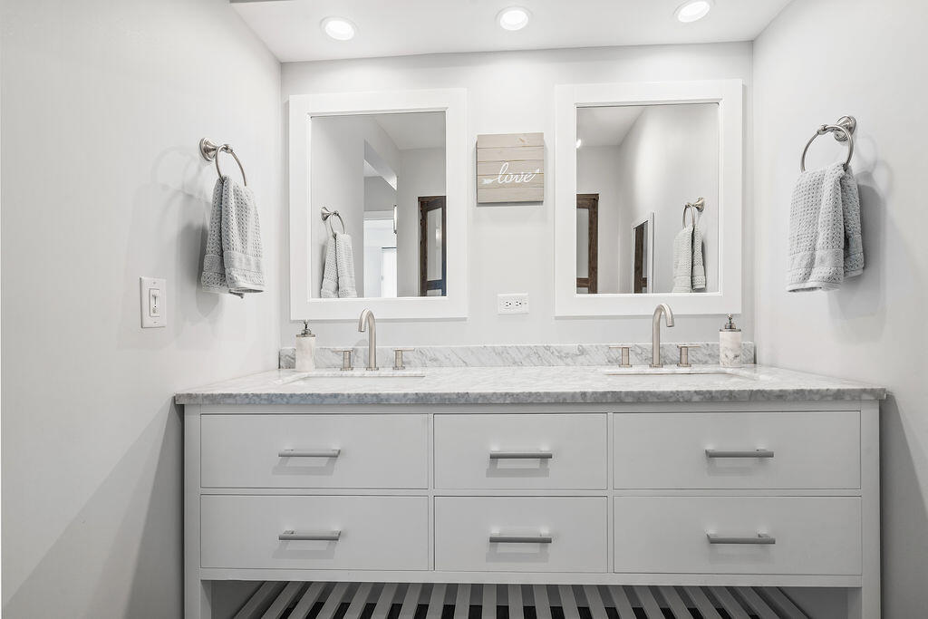 300 Ocean Trail Way, Unit 301 Jupiter, FL 33477 - Photo 23 of 64 a bathroom with a sink double vanity and a mirror