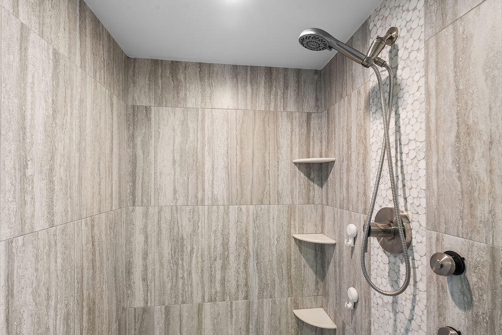 300 Ocean Trail Way, Unit 301 Jupiter, FL 33477 - Photo 26 of 64 a bathroom with a shower curtain