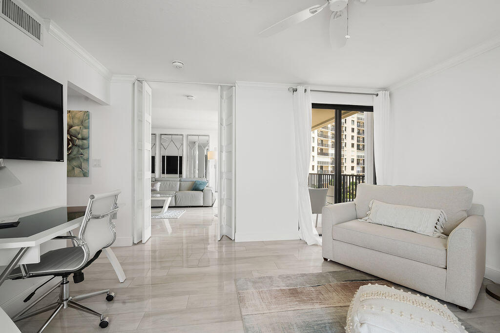 300 Ocean Trail Way, Unit 301 Jupiter, FL 33477 - Photo 33 of 64 a living room with furniture and a flat screen tv