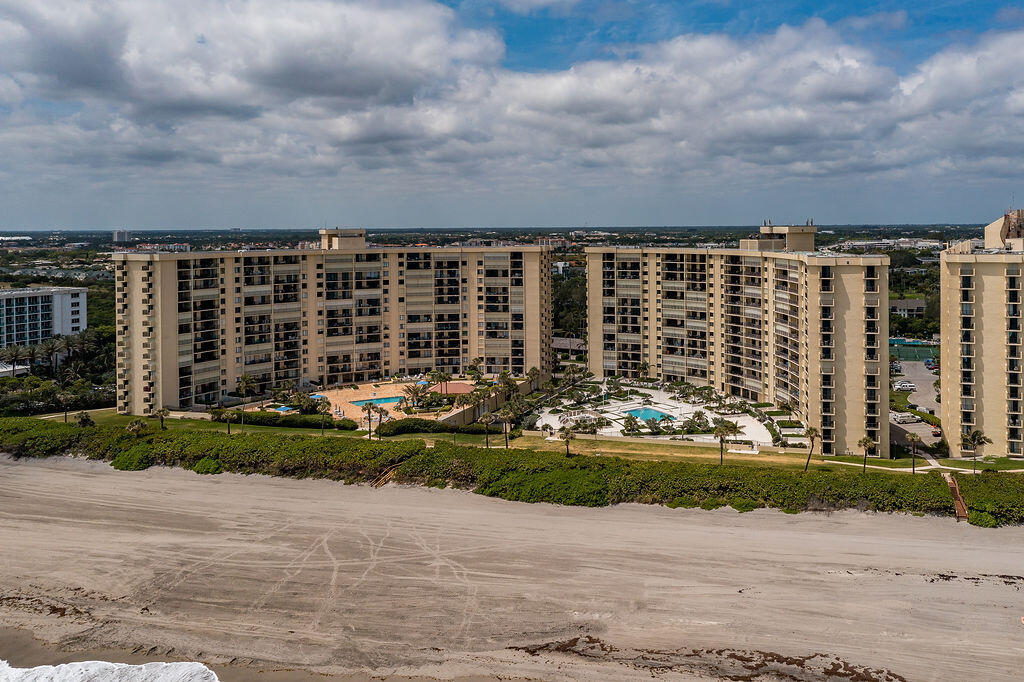 300 Ocean Trail Way, Unit 301 Jupiter, FL 33477 - Photo 50 of 64 a view of building with yard and barbeque oven