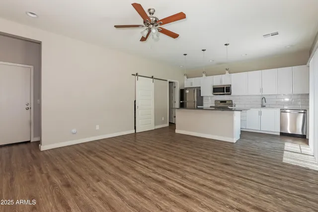 a view of a kitchen with microwave and cabinets