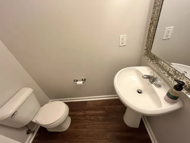 a bathroom with a sink mirror and toilet