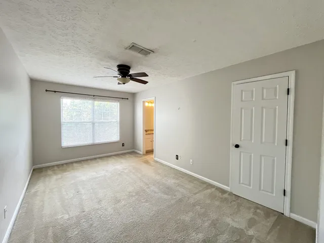 a view of an empty room and a window