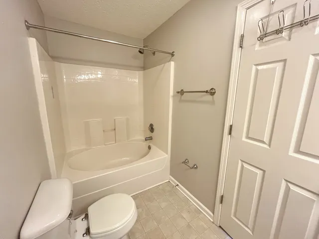 a bathroom with a toilet and a bathtub