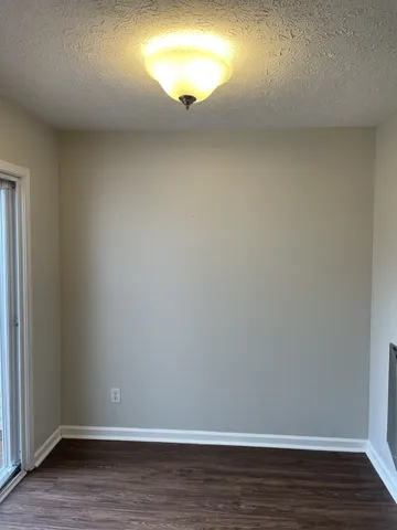 a view of an empty room and wooden floor