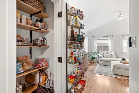 a living room with furniture and a book shelf