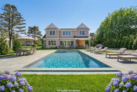 a swimming pool view with a seating space and a garden view