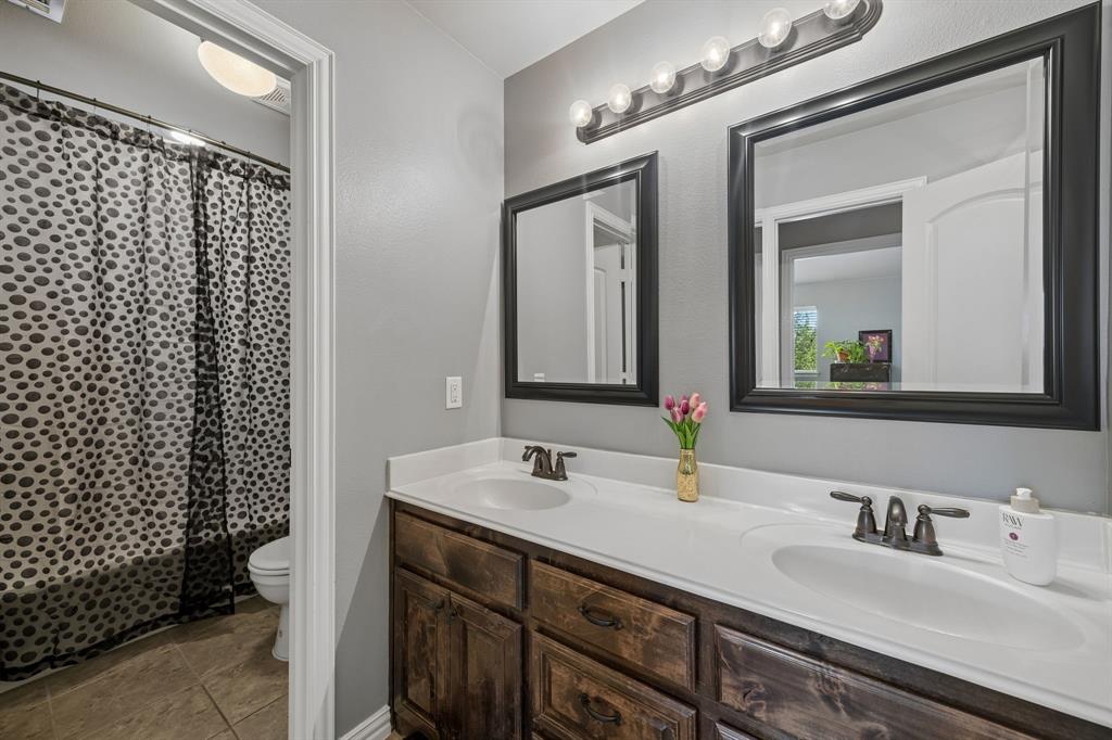 8104 Red Riv Run North Richland Hills, TX 76180 - Photo 29 of 38 a bathroom with a double vanity sink and a mirror
