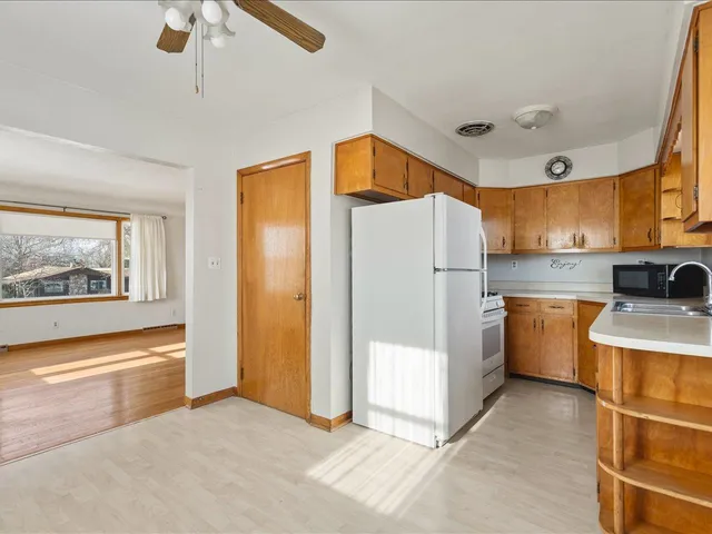 a kitchen with refrigerator and cabinets