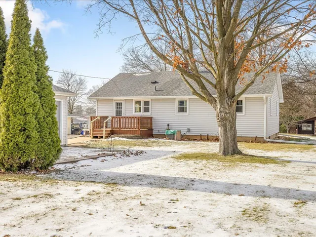 a view of a house with a snow in the background