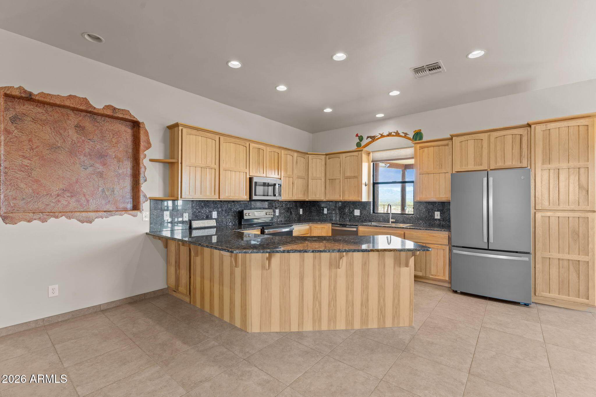 21800 West Hawkeye Road Congress, AZ 85332 - Photo 29 of 61 a kitchen with stainless steel appliances kitchen island granite countertop a refrigerator and a stove top oven