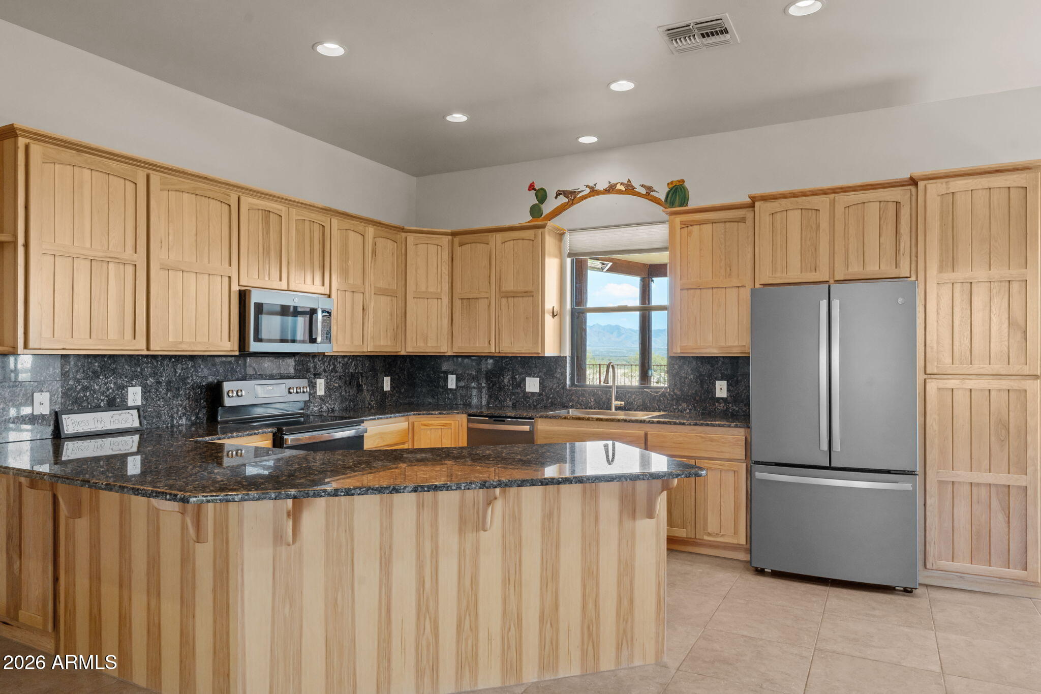 21800 West Hawkeye Road Congress, AZ 85332 - Photo 30 of 61 a kitchen with stainless steel appliances granite countertop a refrigerator sink and cabinets