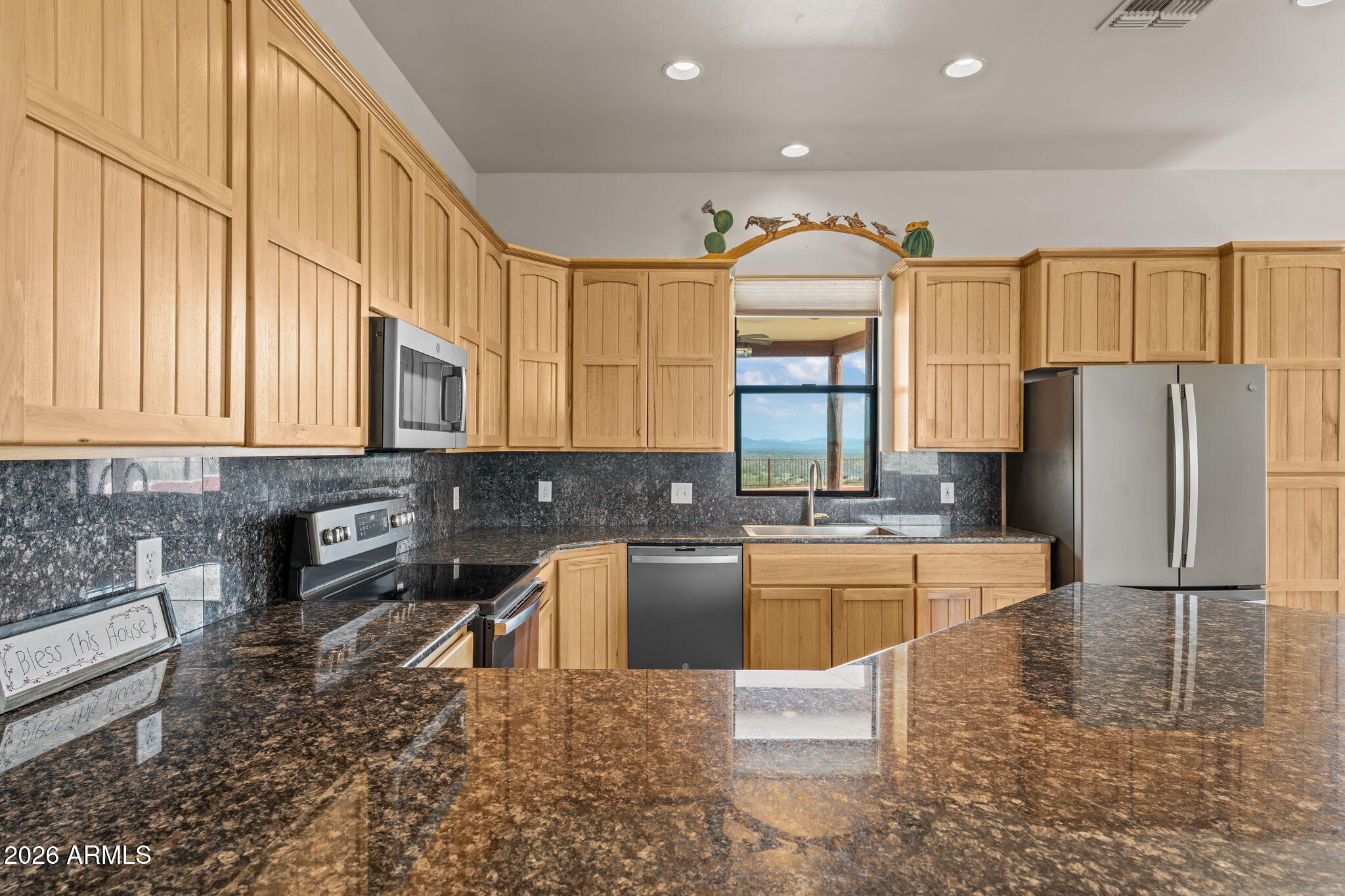 21800 West Hawkeye Road Congress, AZ 85332 - Photo 34 of 61 a kitchen with stainless steel appliances granite countertop a refrigerator a stove and a sink with granite countertops