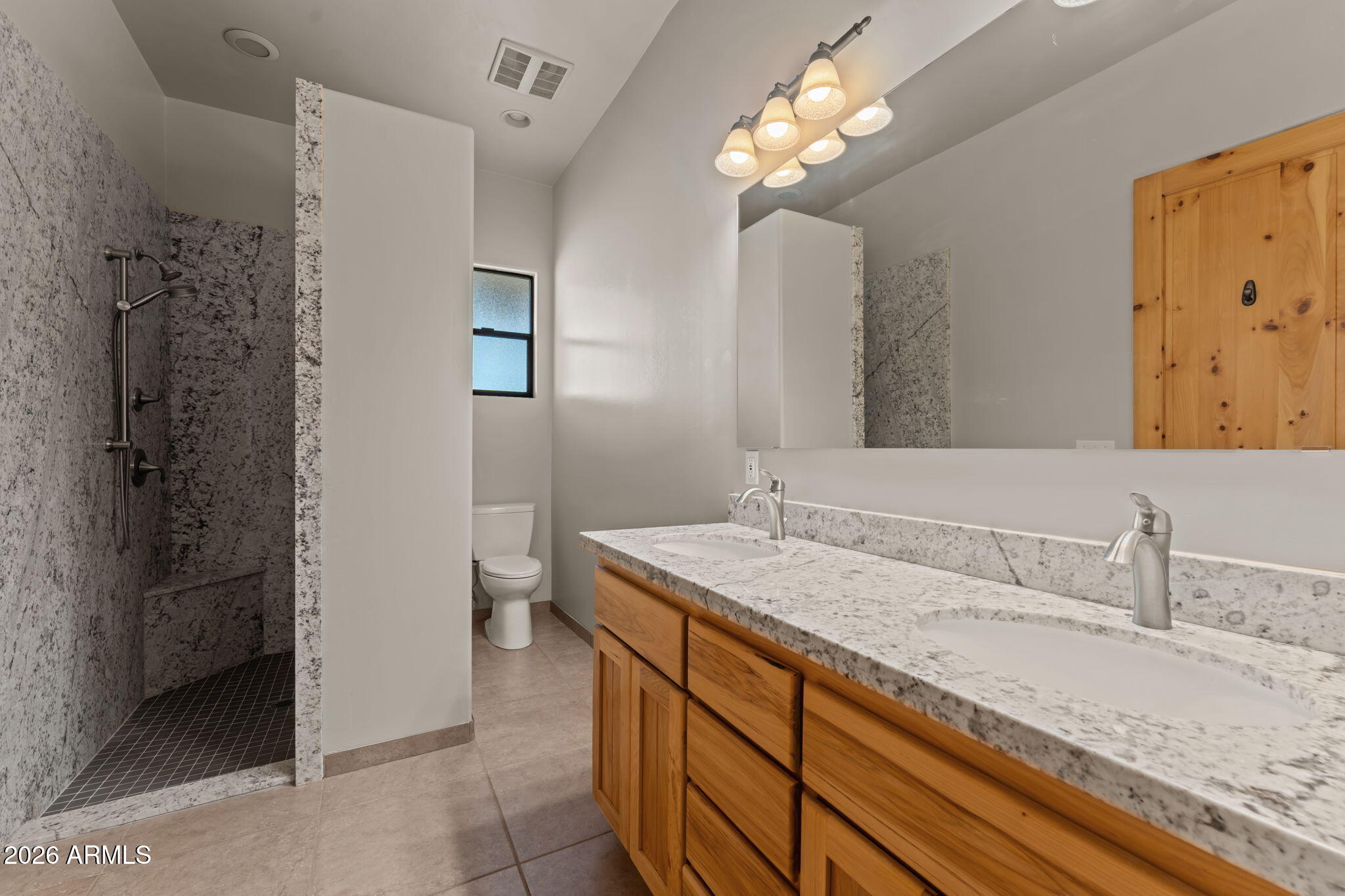 21800 West Hawkeye Road Congress, AZ 85332 - Photo 43 of 61 a bathroom with a granite countertop sink a toilet and shower
