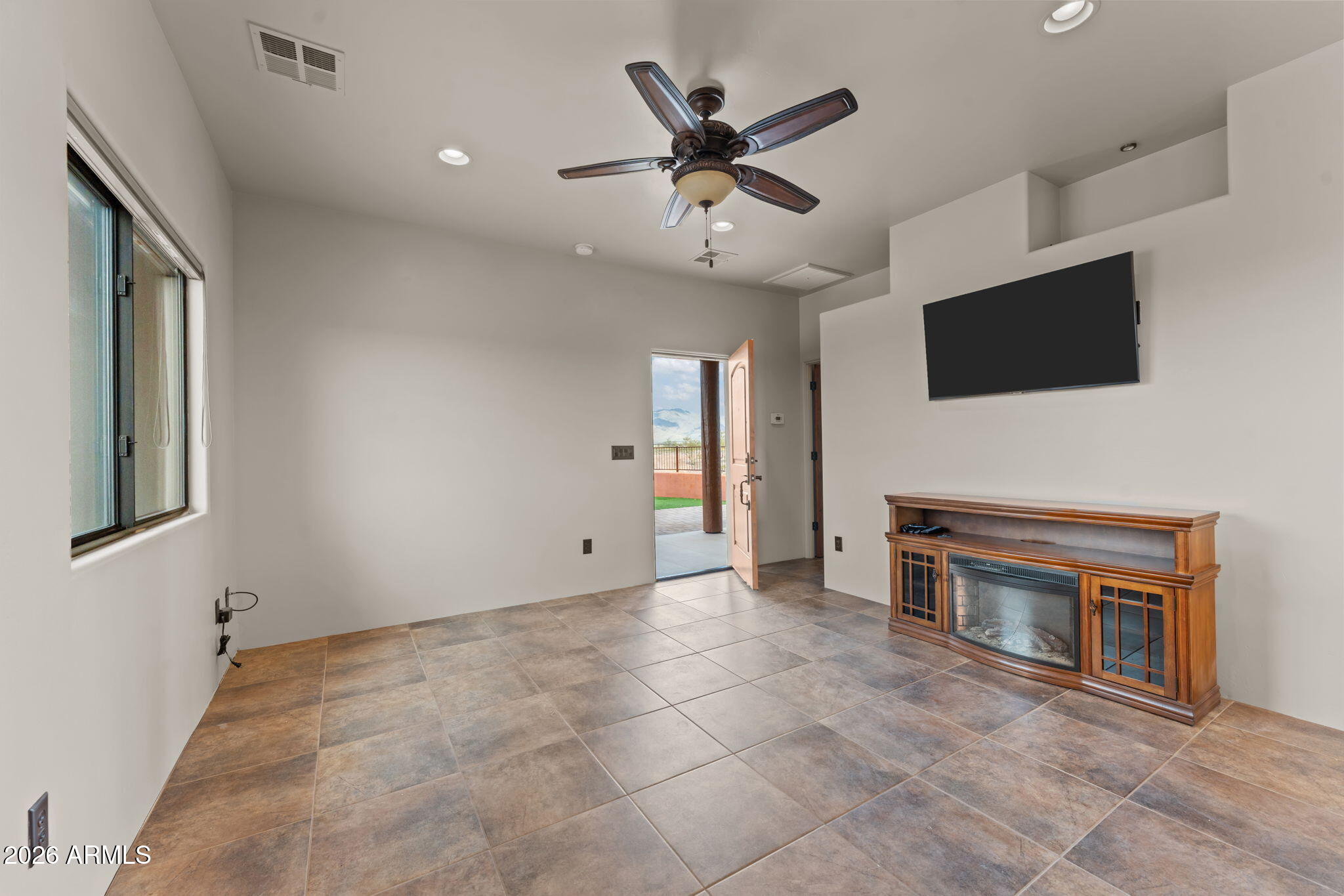 21800 West Hawkeye Road Congress, AZ 85332 - Photo 56 of 61 a view of an empty room with a fireplace and a ceiling fan