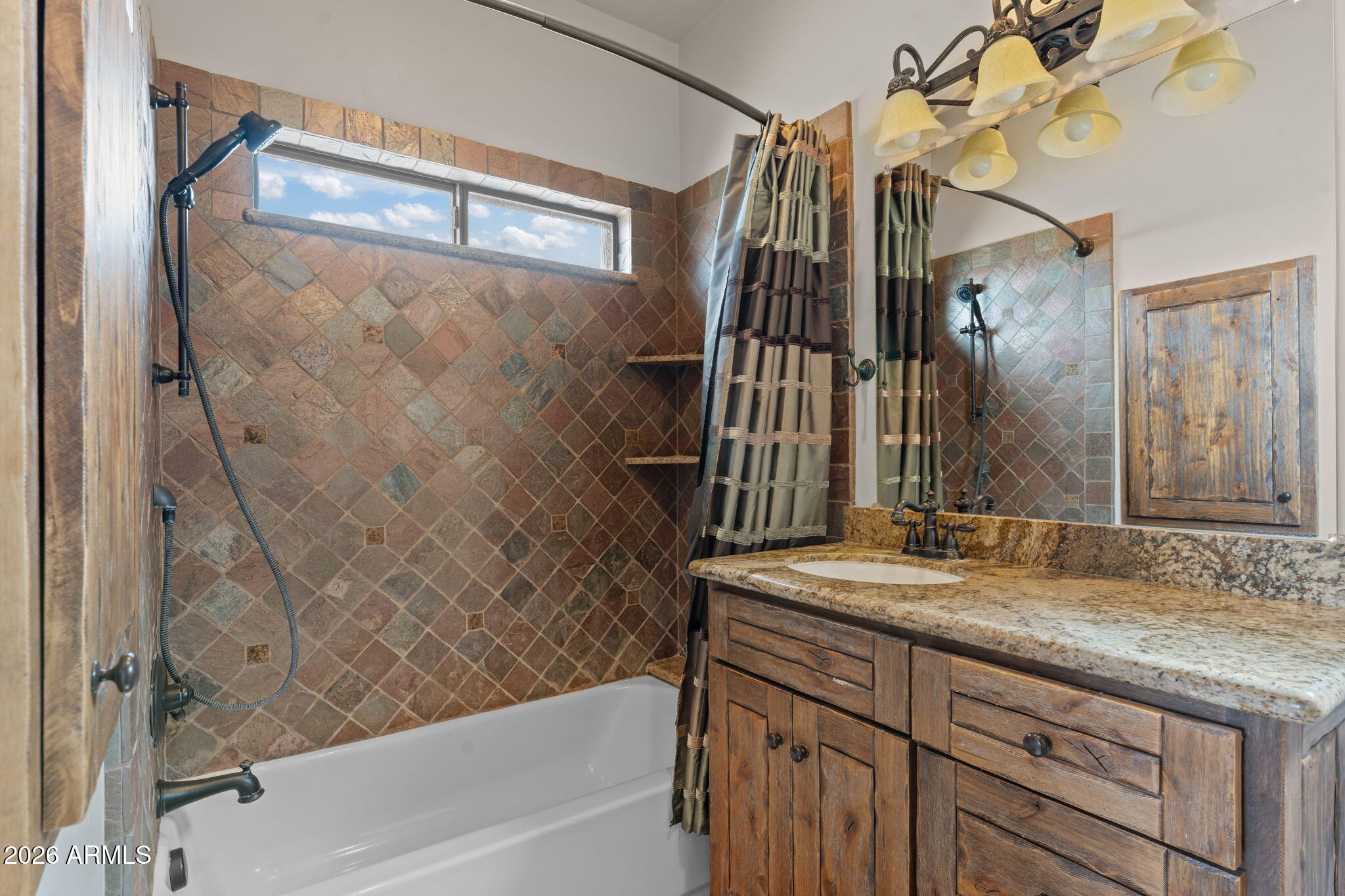 21800 West Hawkeye Road Congress, AZ 85332 - Photo 61 of 61 a bathroom with a granite countertop sink a mirror and a bathtub