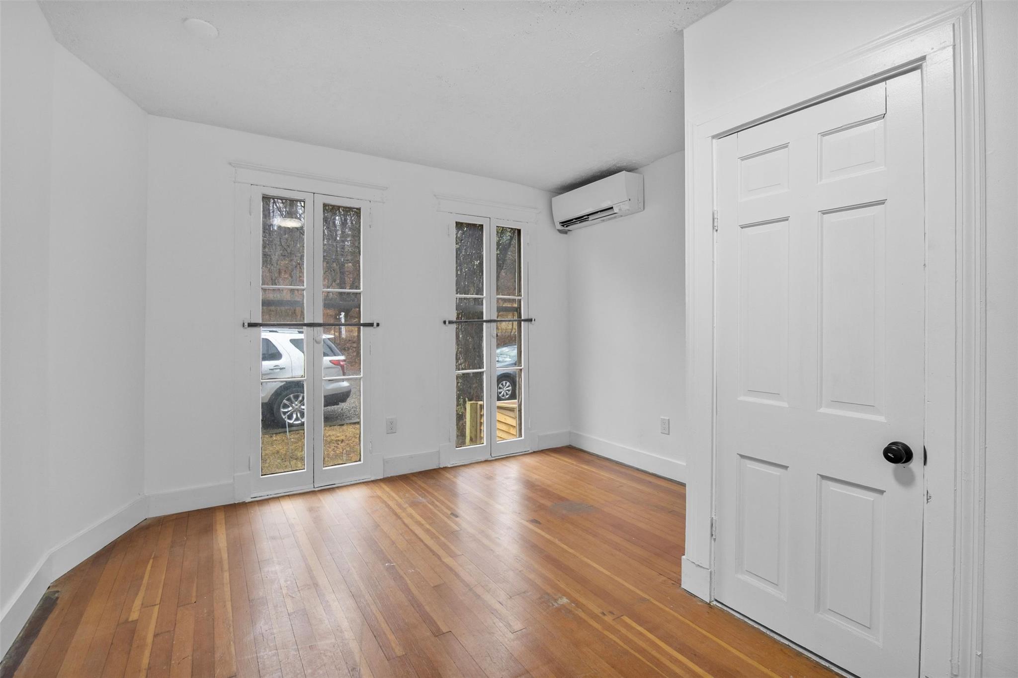 wooden floor in an empty room with a window