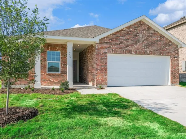 a front view of a house with a yard and pathway
