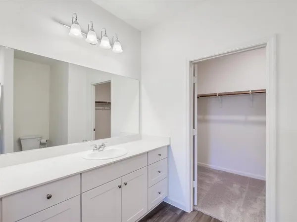 a bathroom with a double vanity sink and a mirror