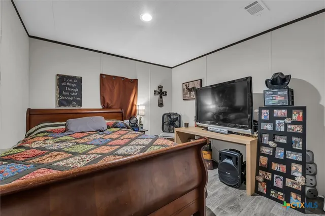 a bedroom with a bed and a flat screen tv