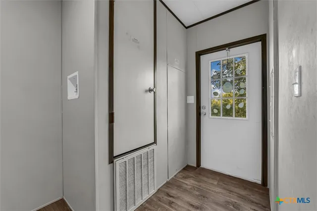 a view of a hallway with wooden floor