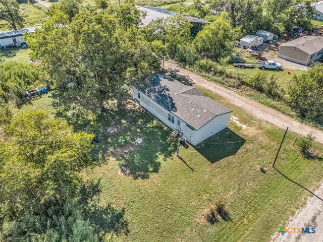 an aerial view of a house with yard
