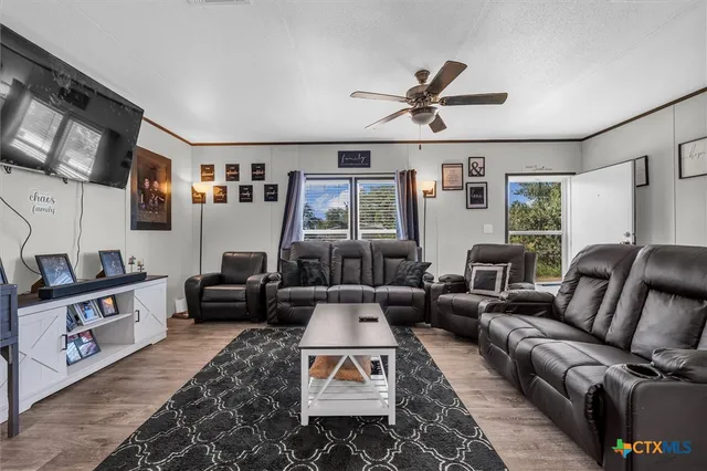 a living room with furniture fireplace and a window