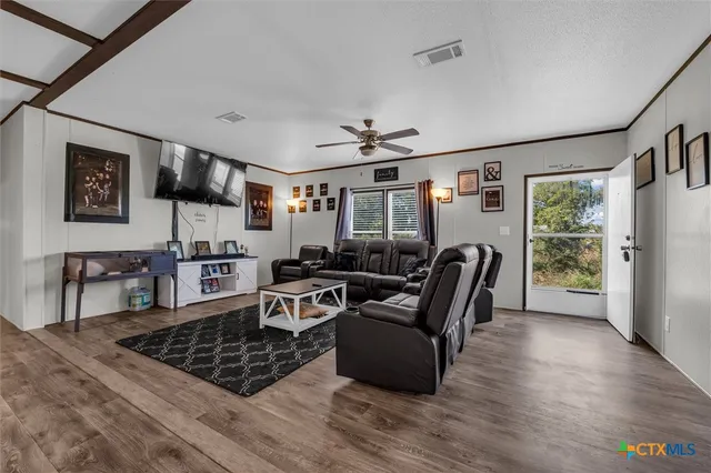 a living room with furniture a rug and a window