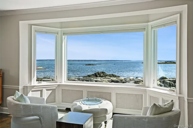 a dining room with furniture and a large window