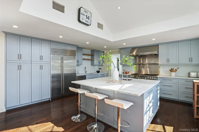 a kitchen with a stove a refrigerator a sink and a microwave