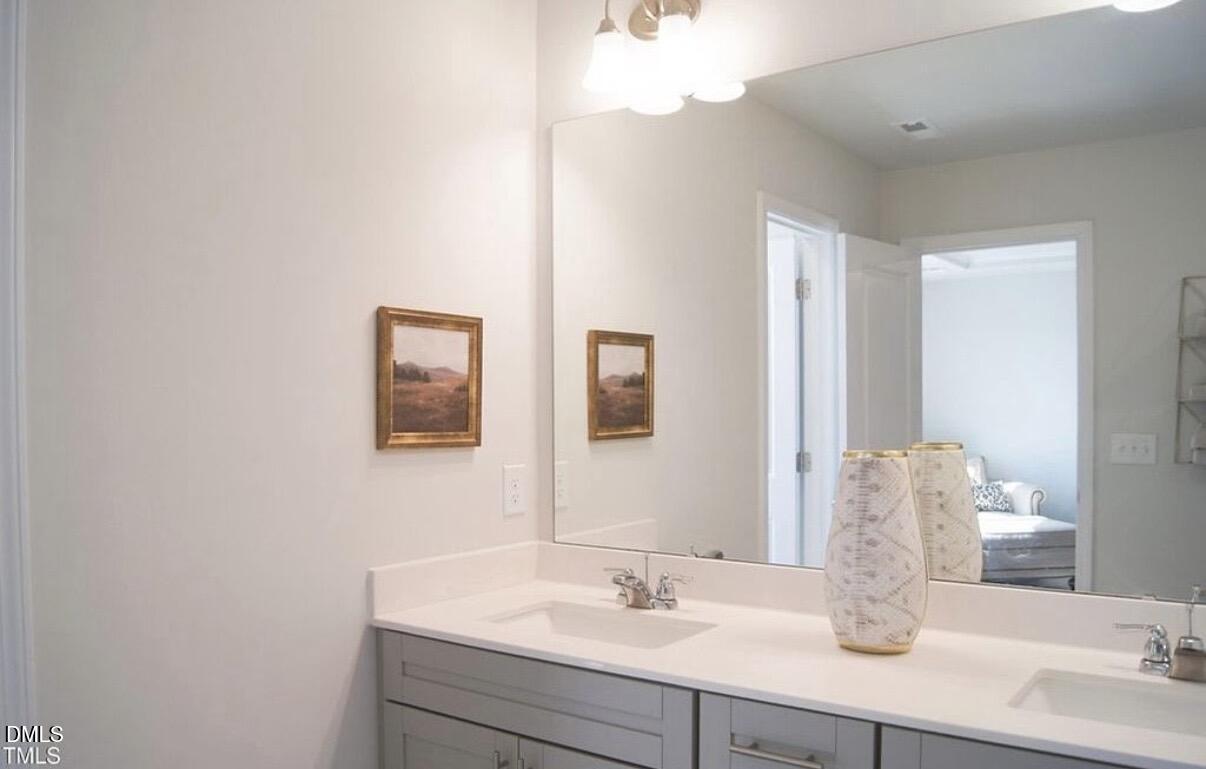 5006 Tura Street Raleigh, NC 27610 - Photo 20 of 32 a bathroom with a sink and a mirror