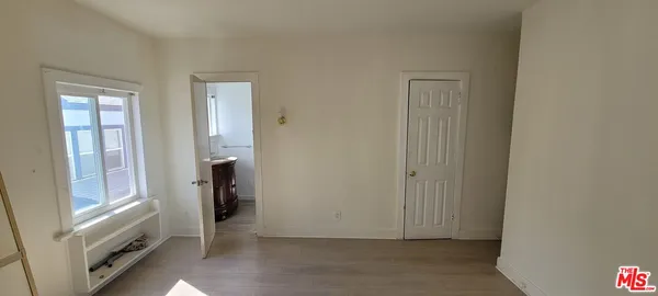 a view of entryway with window and wooden floor