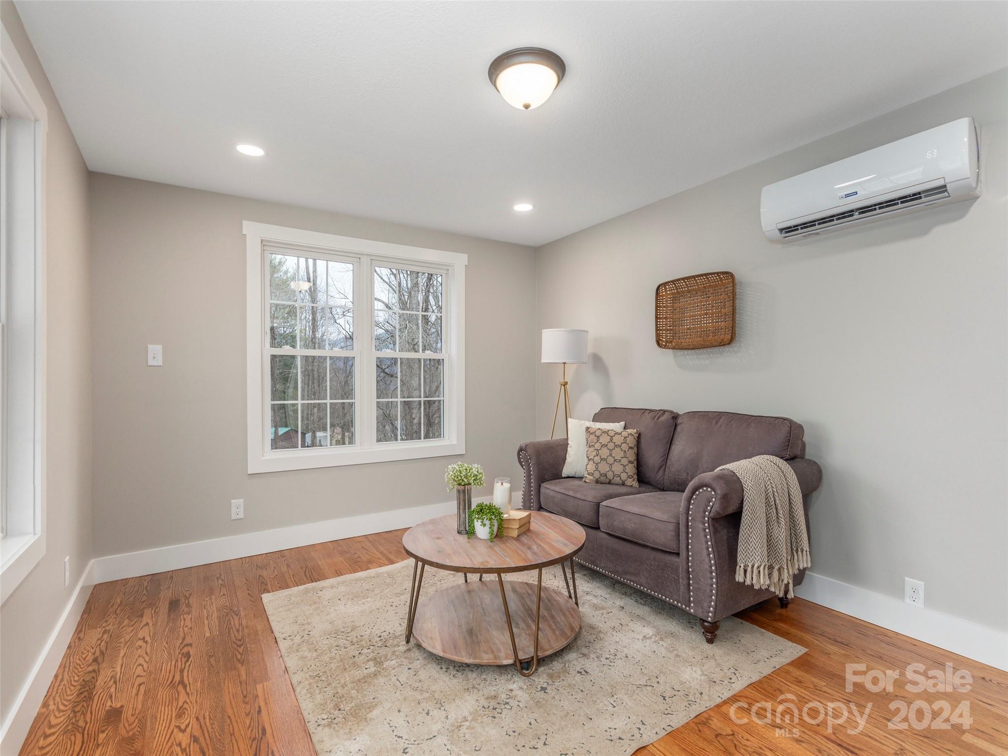 65 Squaw Ridge Road Waynesville, NC 28786 - Photo 12 of 24 a living room with furniture and a large window