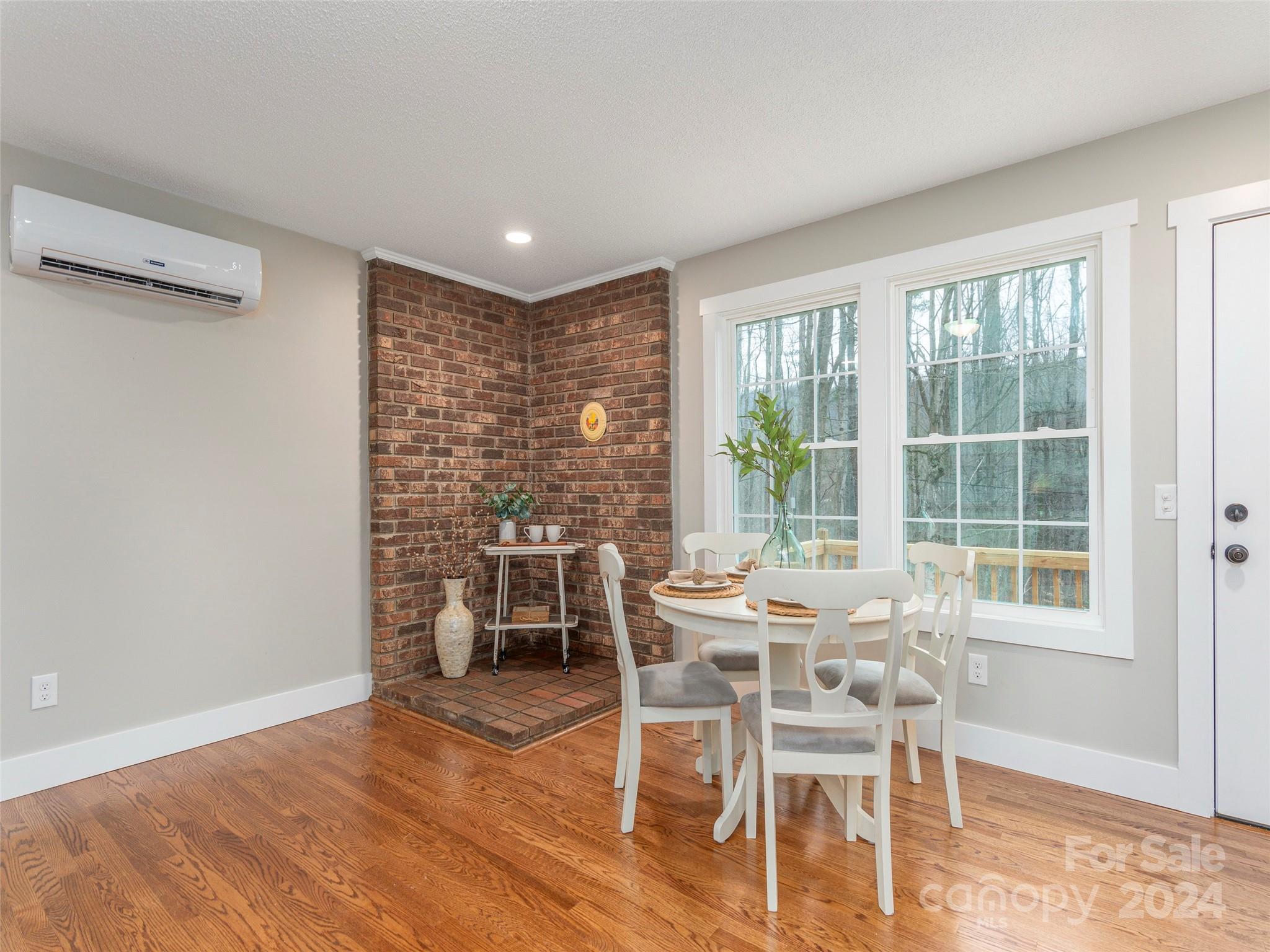 65 Squaw Ridge Road Waynesville, NC 28786 - Photo 15 of 24 a dining room with furniture and wooden floor