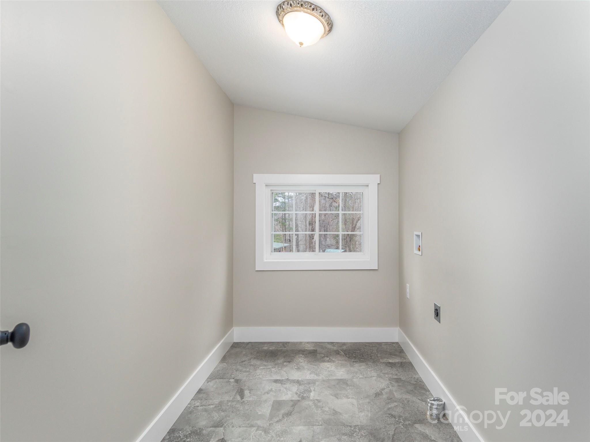 65 Squaw Ridge Road Waynesville, NC 28786 - Photo 16 of 24 an empty room with a window