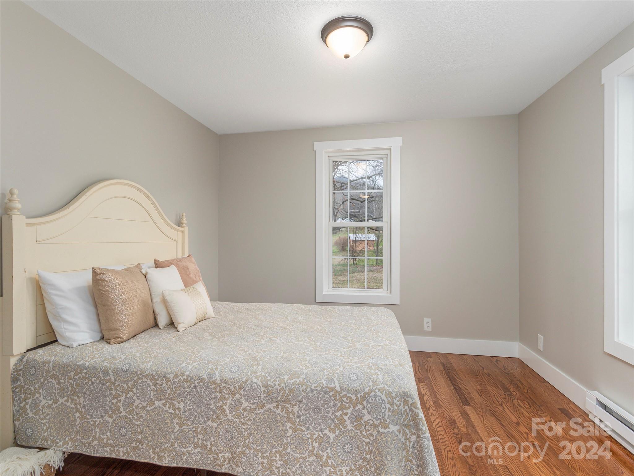 65 Squaw Ridge Road Waynesville, NC 28786 - Photo 17 of 24 a bedroom with a bed and a window