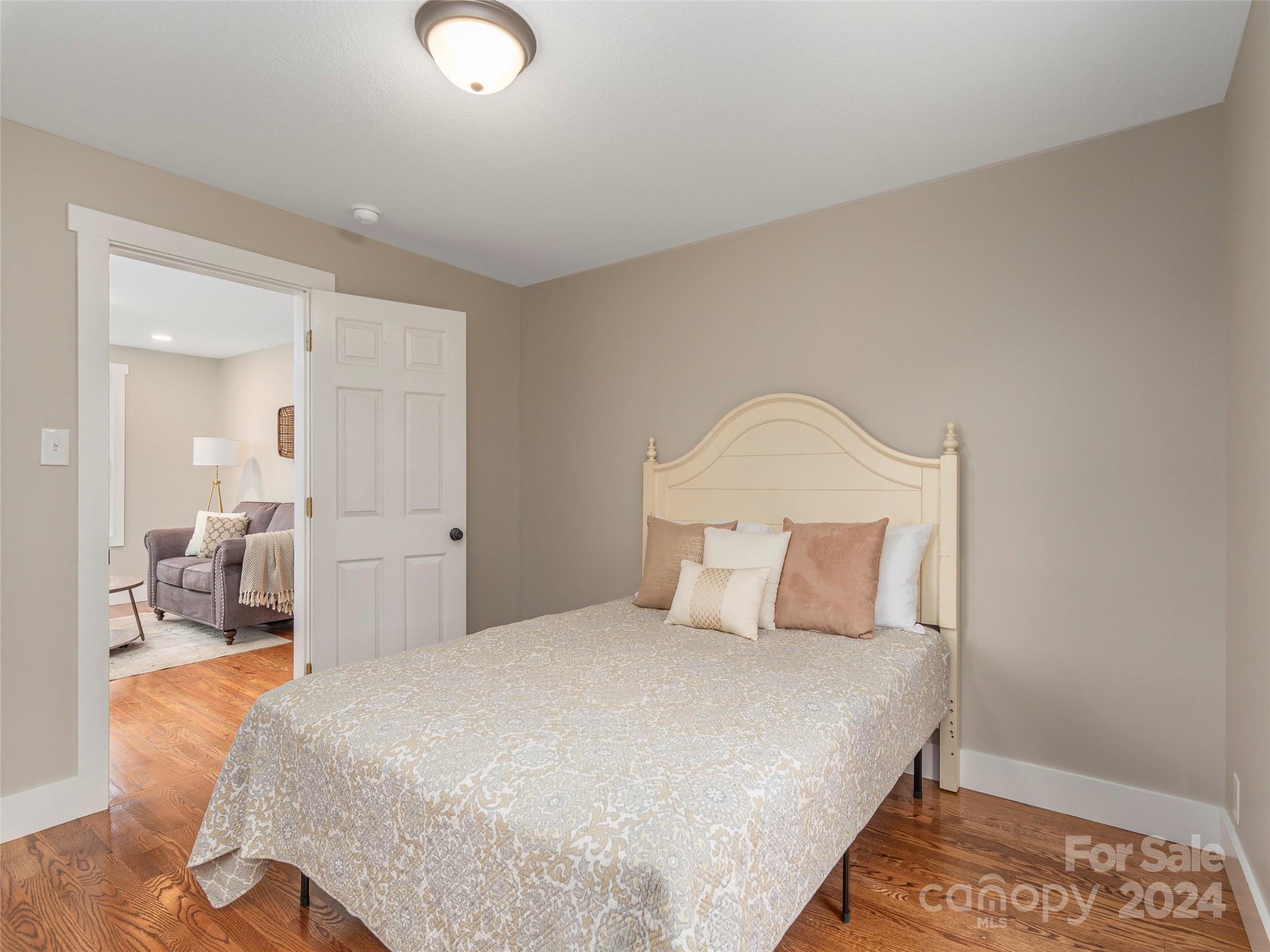65 Squaw Ridge Road Waynesville, NC 28786 - Photo 18 of 24 a bedroom with a bed and a mirror