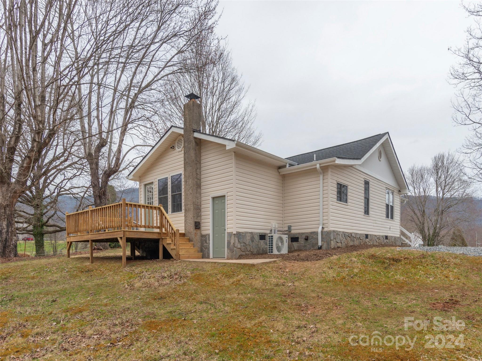 65 Squaw Ridge Road Waynesville, NC 28786 - Photo 8 of 24 a house that has a tree in front of it