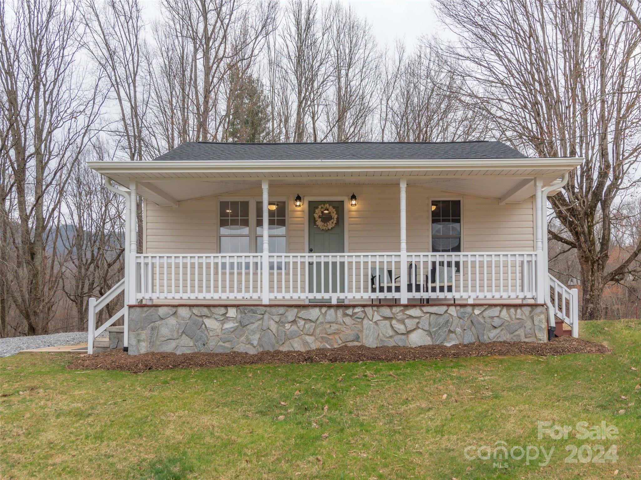 65 Squaw Ridge Road Waynesville, NC 28786 - Photo 9 of 24 a view of a house with a yard and a deck
