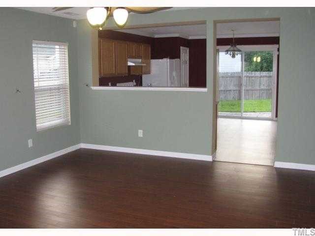 7203 Monarda Court Raleigh, NC 27616 - Photo 2 of 12 Family Room with gorgeous laminate floors and pass through to kitchen.