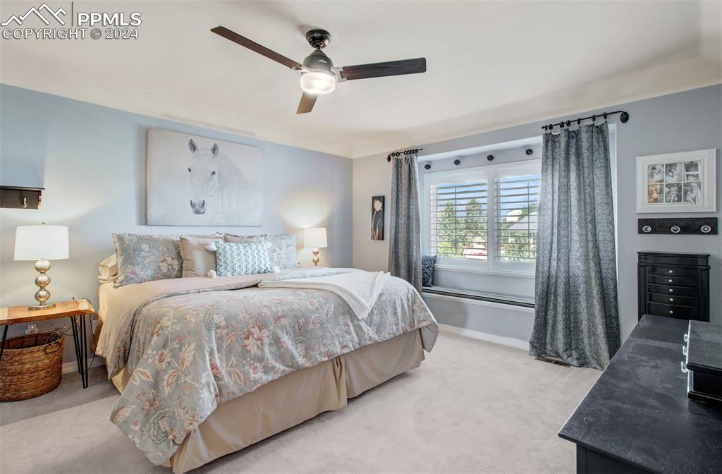 12110 Lazy E Road Peyton, CO 80831 - Photo 14 of 50 a spacious bedroom with a bed and a window