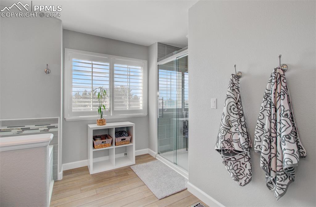 12110 Lazy E Road Peyton, CO 80831 - Photo 17 of 50 a view of a room with a window and wooden floor