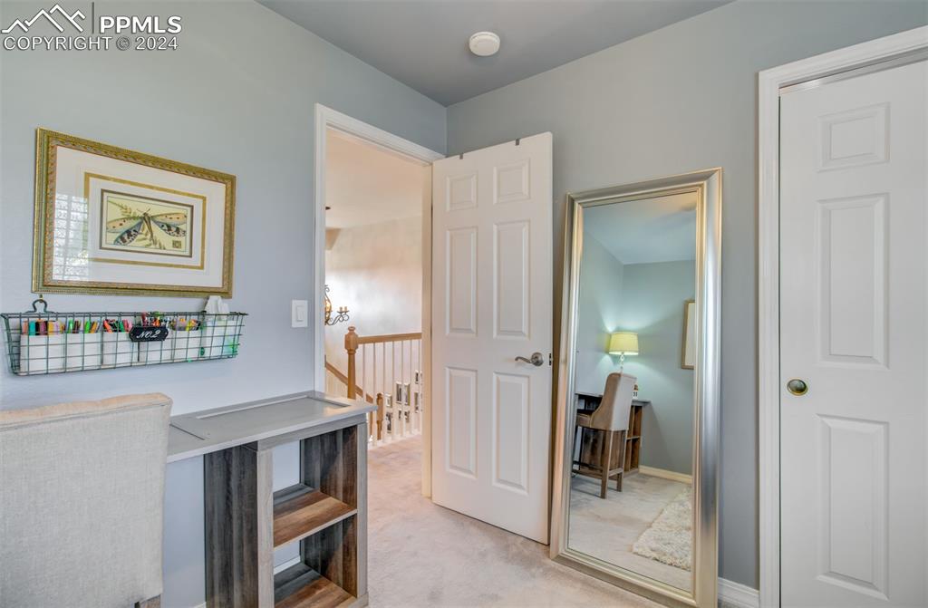 12110 Lazy E Road Peyton, CO 80831 - Photo 19 of 50 a view of a hallway with bathroom and front door