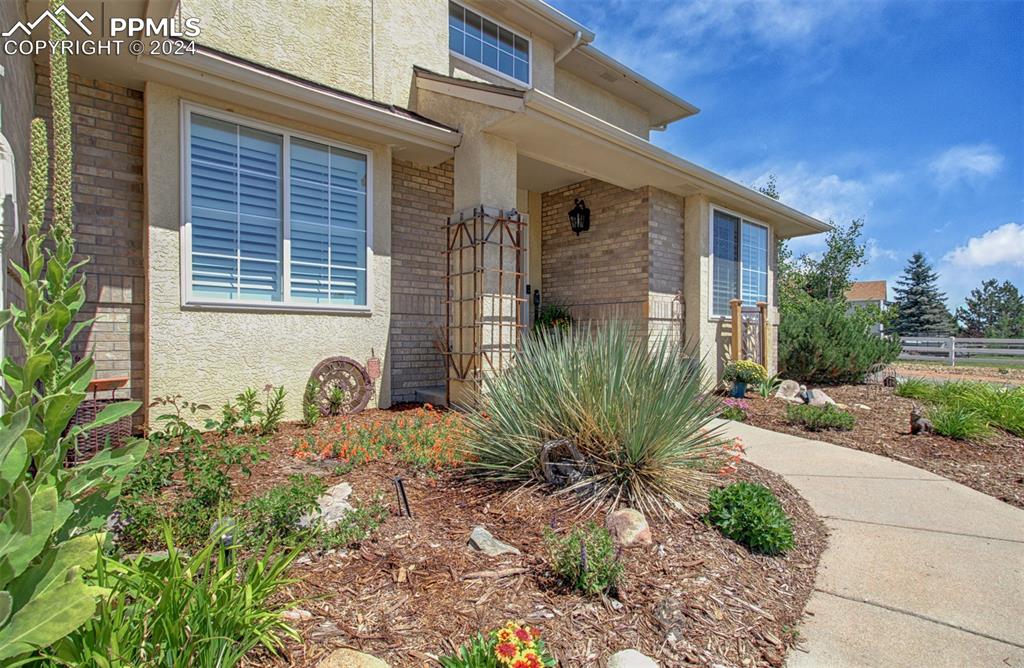 12110 Lazy E Road Peyton, CO 80831 - Photo 2 of 50 a front view of a house with garden