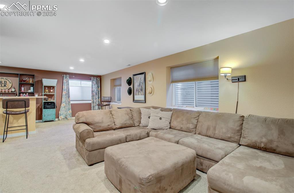12110 Lazy E Road Peyton, CO 80831 - Photo 24 of 50 a living room with furniture and a large window