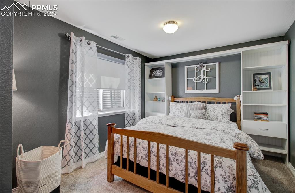 12110 Lazy E Road Peyton, CO 80831 - Photo 28 of 50 a bedroom with a bed and a window