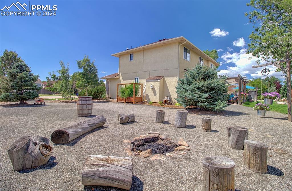 12110 Lazy E Road Peyton, CO 80831 - Photo 34 of 50 a view of a backyard with table and chairs potted plants
