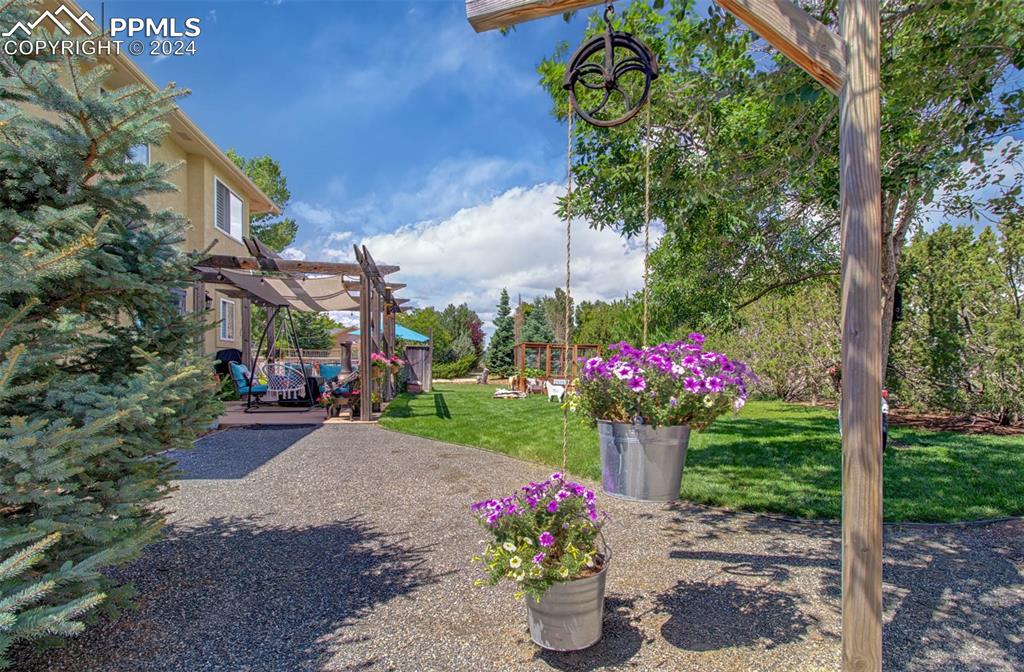12110 Lazy E Road Peyton, CO 80831 - Photo 38 of 50 a front view of a house with a yard and fountain