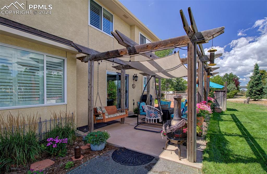 12110 Lazy E Road Peyton, CO 80831 - Photo 41 of 50 a building outdoor space with patio furniture and potted plants