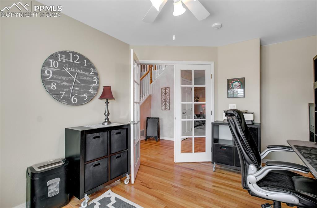 12110 Lazy E Road Peyton, CO 80831 - Photo 5 of 50 a view of a workspace with furniture and wooden floor
